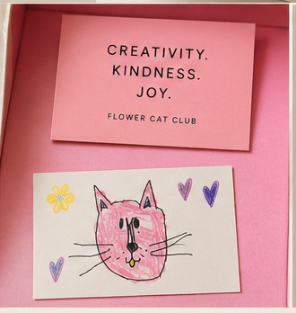 Creativity. Kindness. Joy. card beside a print of Mila's original cat drawing